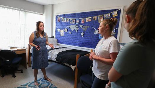 a campus tour guide shows off a residence hall